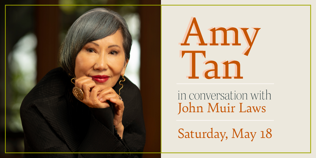 A woman sitting with her head in her hands smiling to the camera. Amy Tan in conversation with John Muir Laws. Saturday, May 18.
